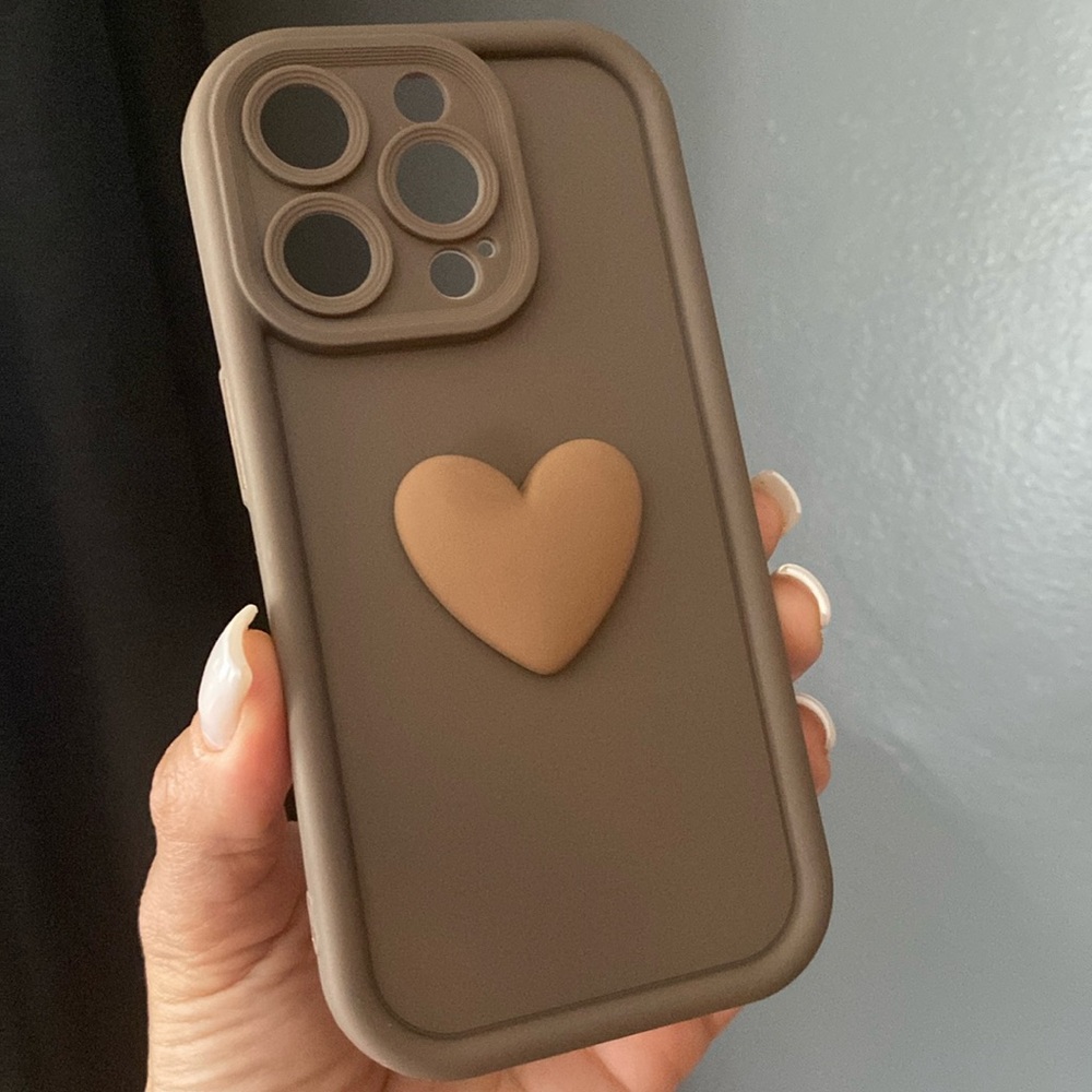 iPhone 15 pro brown flexible case with a 3D heart decoration